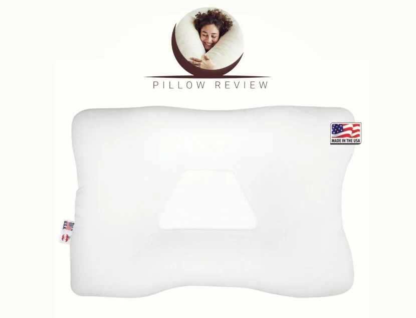 Core Products Tri-Core Cervical Support Pillow Review: A Solution for Neck and Back Pain? A white orthopedic pillow with an indentation in the center and a "Made in the USA" label. The top of the image features a person sleeping on a pillow with the text "Pillow Review.